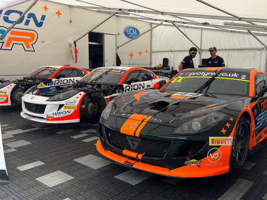 RRS Store team members meeting and talking with race team customers in the Oulton Park paddock during a British GT round.