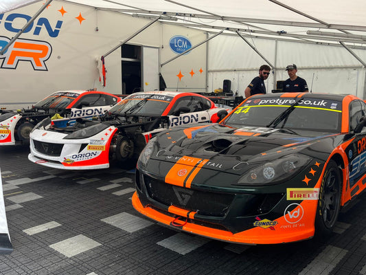RRS Store team members meeting and talking with race team customers in the Oulton Park paddock during a British GT round.