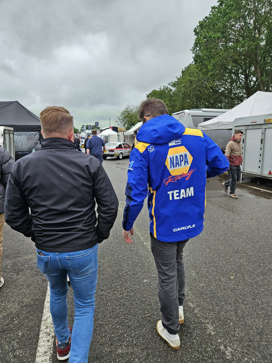 RRS team staff walking alongside a NAPA Racing driver in the paddock at a BTCC championship round.