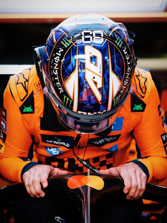 A close-up shot of an artist intricately airbrushing vibrant, detailed neon geometric graphics onto a sleek racing helmet