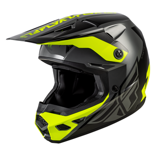 Front three-quarter view of the FLY Racing Kinetic Crest Helmet in yellow displaying the sharp geometric graphic scheme, integrated roost guard, and high-flow front mouthpiece assembly.