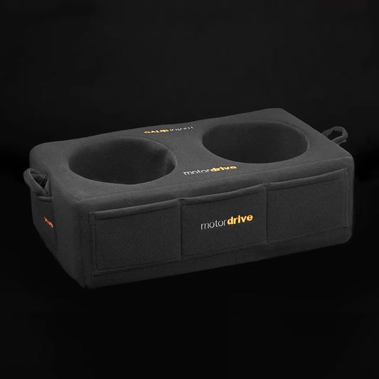 Motordrive premium double helmet box showing the black heavy-duty fully padded canvas construction, three storage pockets stitched across the front face, dual zipper openings, and clean white Motordrive branding on a clean background.